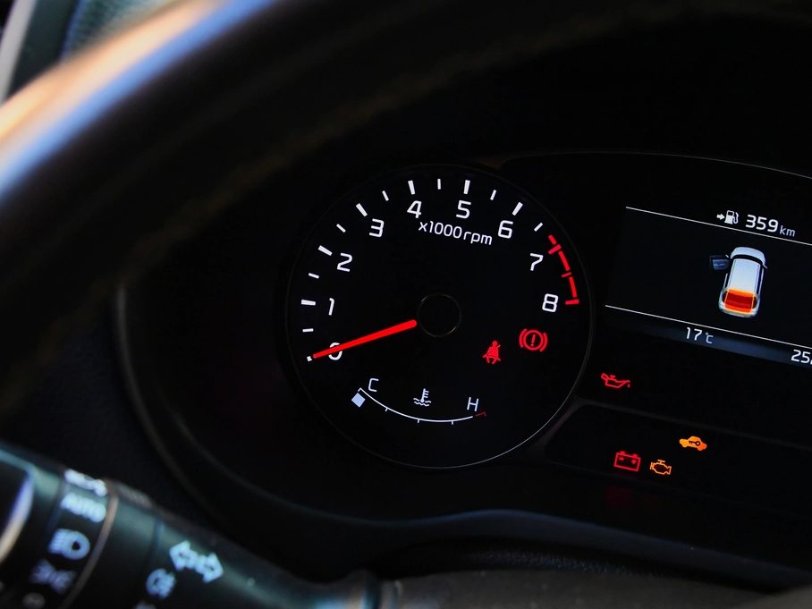 A car's rev counter and dashboard warning lights